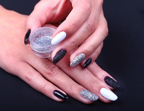 Black, white Nail art manicure. Holiday style bright Manicure with sparkles.